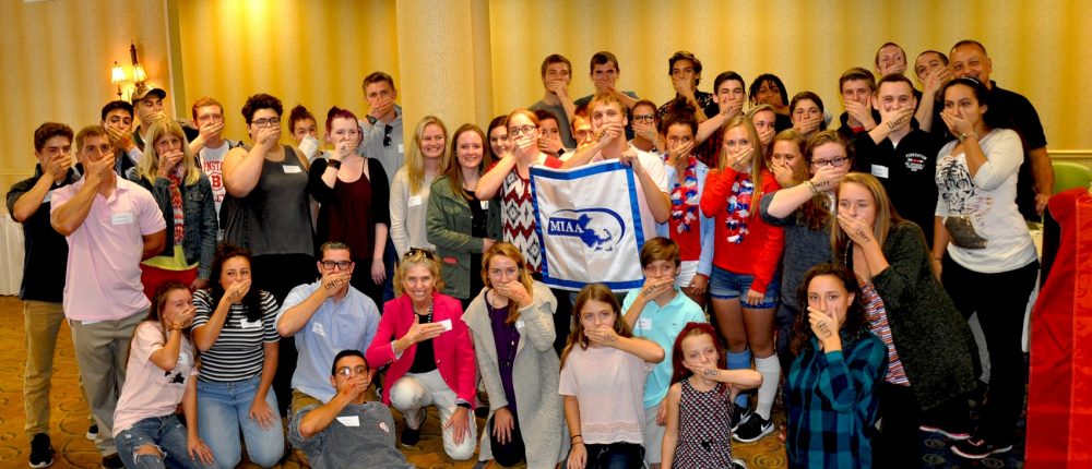 Student athletes cover their mouths as part of an anti-bullying campaign. They were attending an anti-bullying conference that Jonathan Peters helped organize. (Courtesy of Jonathan Peters)