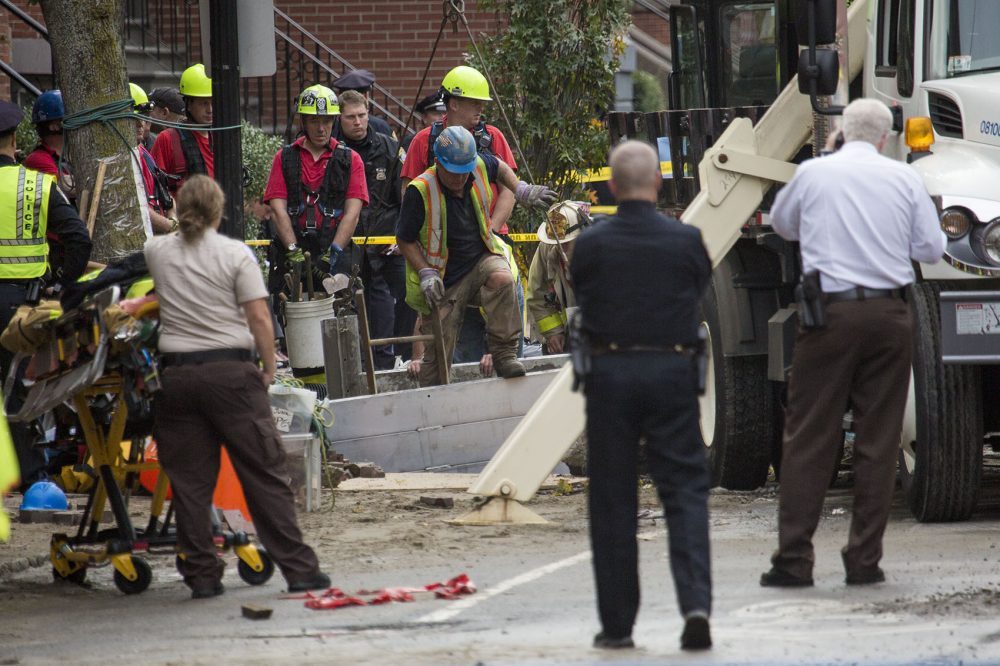A response team works to recover the bodies of two men who were trapped in a trench during a water main break on Dartmouth Street in Boston's South End in October. (Jesse Costa/WBUR)