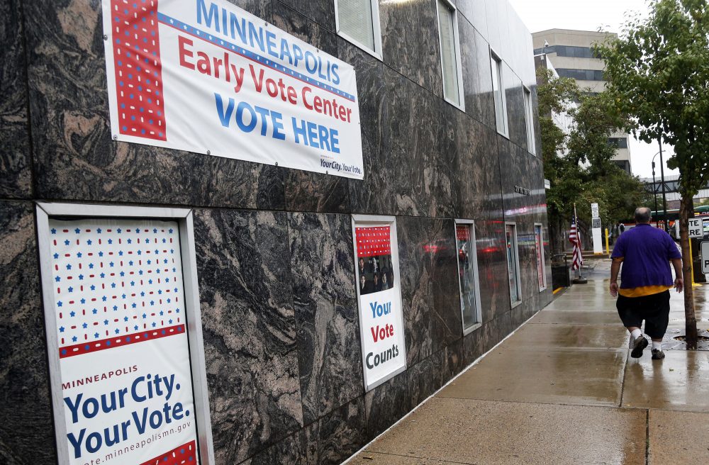 Signs on a building advertise early voting Friday, Sept. 23, 2016, in Minneapolis. Minnesota is one of several states that have rules permitting early voters to change their ballots. (Jim Mone/AP)