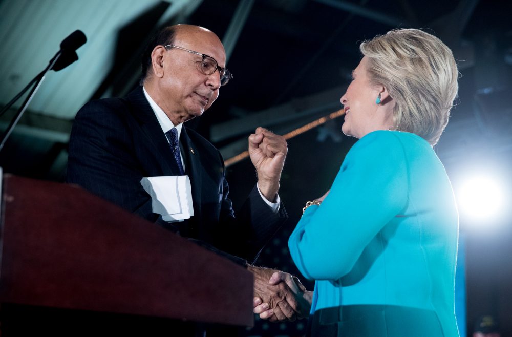Khizr Khan, the father of fallen Army Capt. Humayun Khan, left, introduces Democratic presidential candidate Hillary Clinton, right, during a rally at The Armory at the Radisson Hotel in Manchester, N.H. on Sunday. (Andrew Harnik/AP)