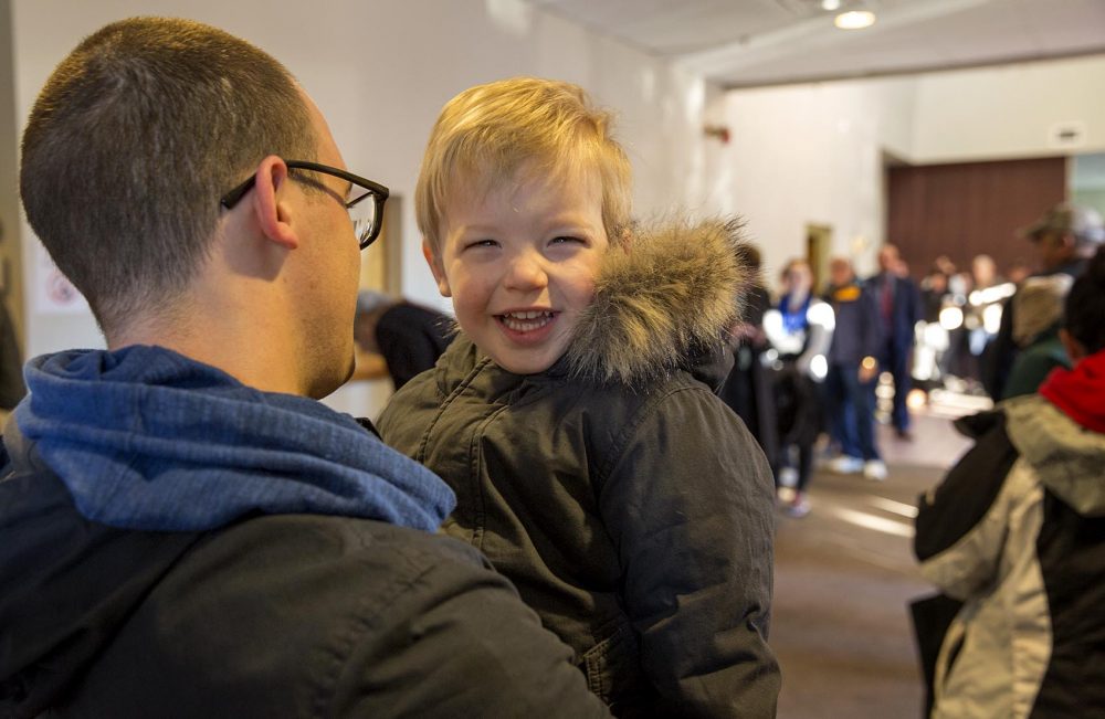 Atticus Burk, 2, waits in long line of voters with his father, Russell, at the Hellenic Center in Watertown, Mass. (Robin Lubbock/WBUR)