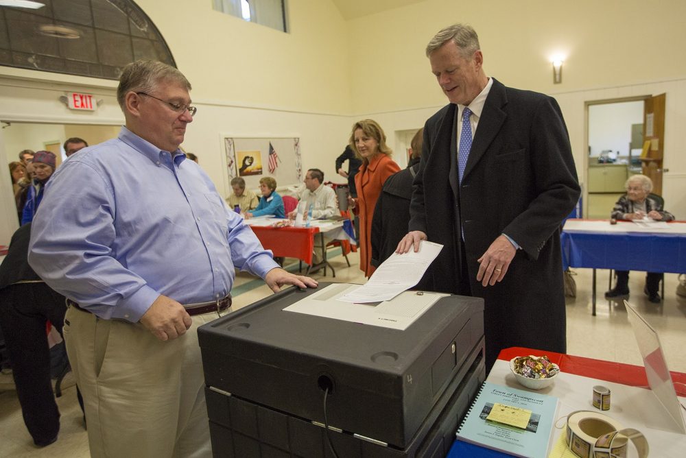 Gov. Charlie Baker casts his ballot on Election Day in Swampscott. He was the 40th person to cast his ballot there. (Jesse Costa/WBUR)