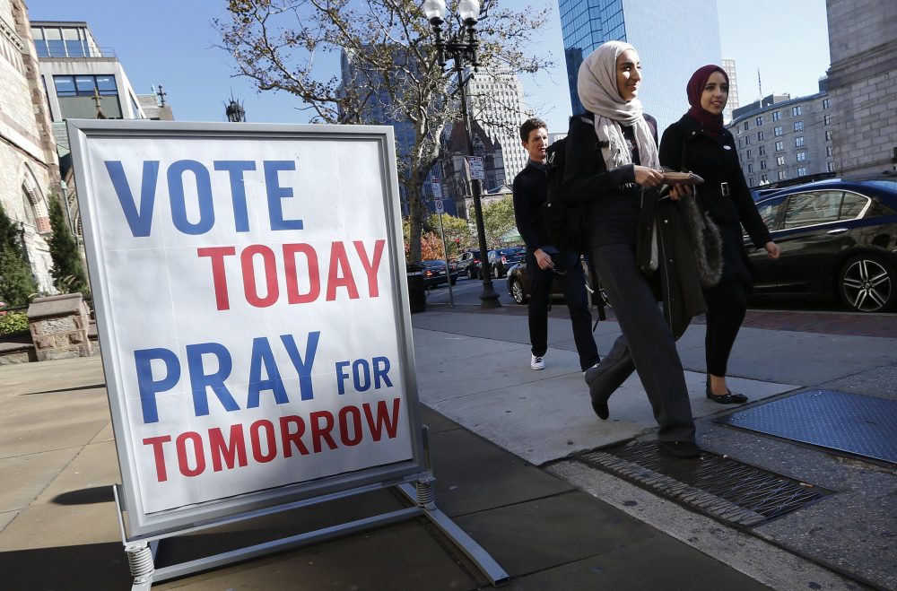 Pedestrians pass a sign promoting prayer and voting outside Old South Church in Boston. (Michael Dwyer/AP)