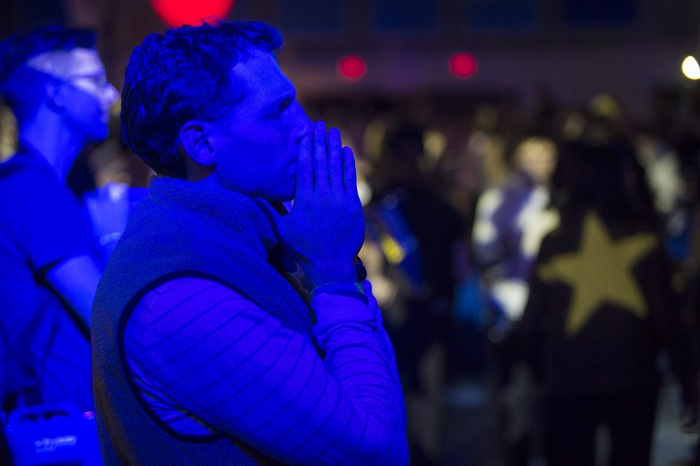 Clinton supporter at Wellesley College praying as the contest is close. (Jesse Costa/WBUR)