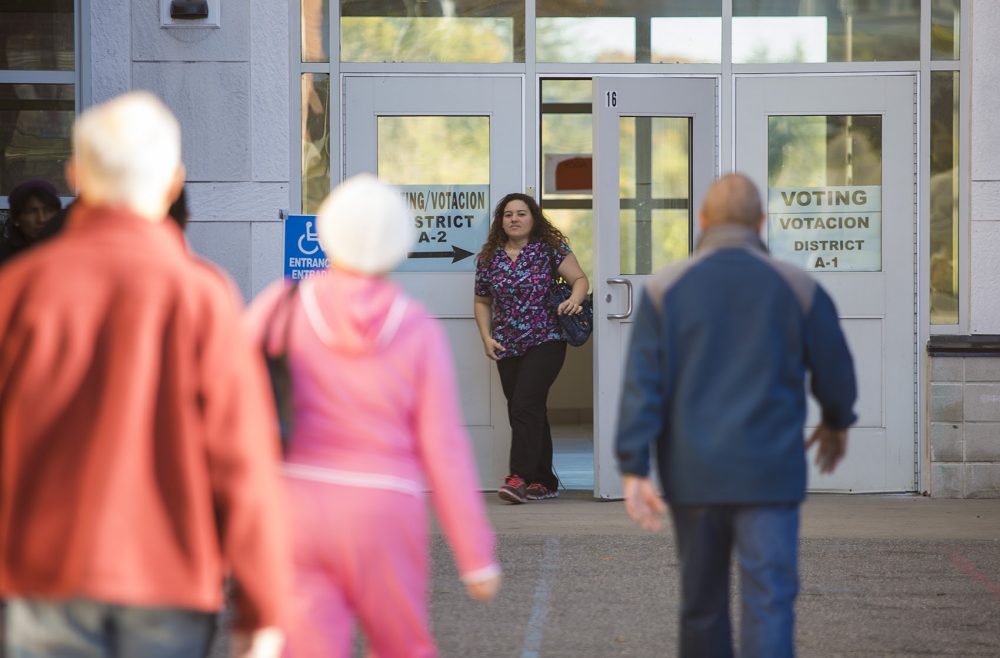 Voters file in and out of Parthum Middle School in Lawrence where voting was very busy. (Jesse Costa/WBUR)