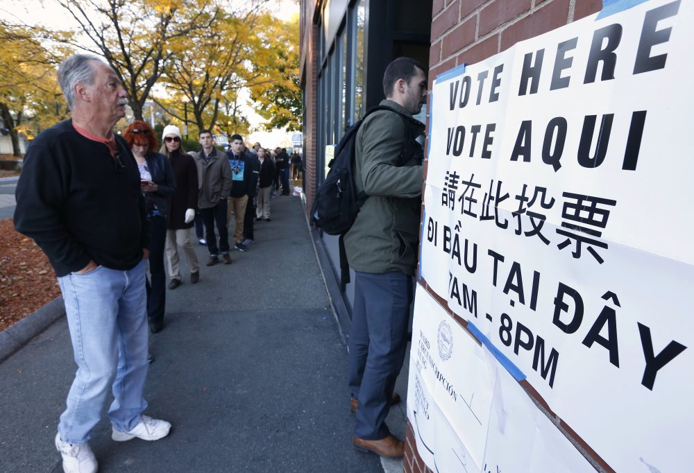 People line up to vote in the East Boston neighborhood of Boston on Tuesday. (Michael Dwyer/AP)