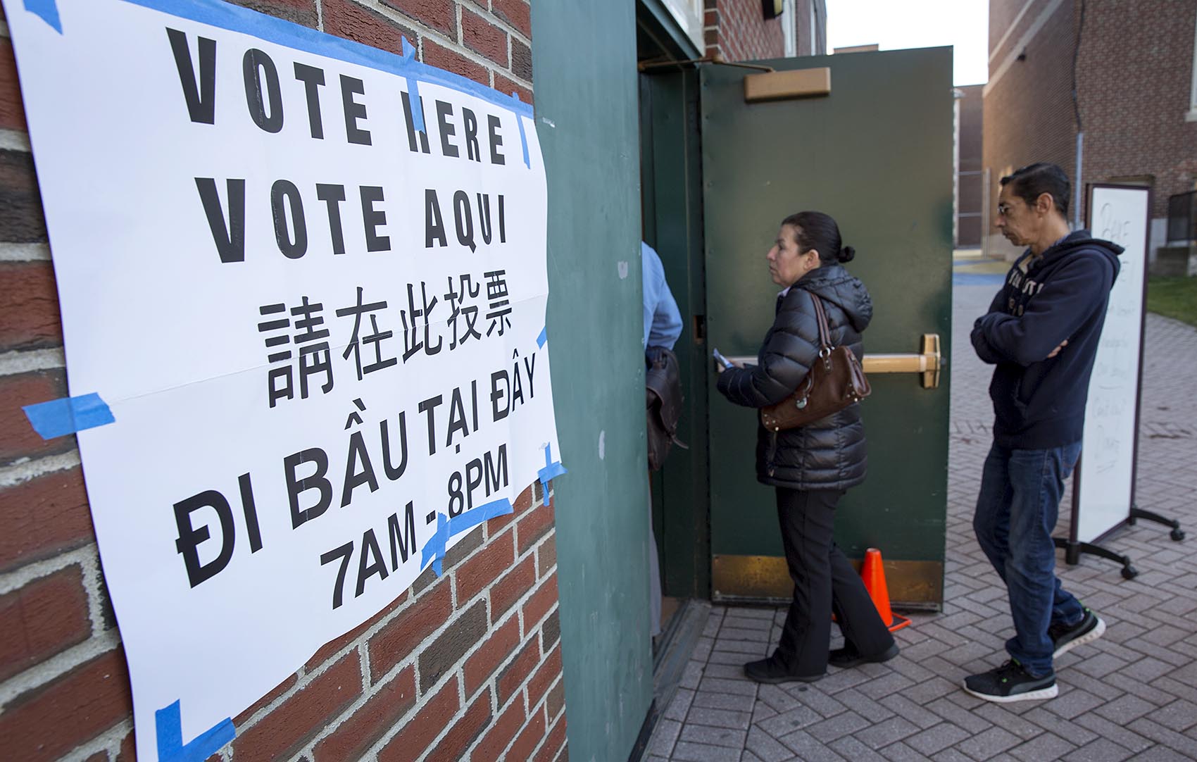 Between early voting and Election Day, about 3.4 million ballots were cast by Massachusetts voters -- eclipsing the previous record of 3.18 million votes in 2012. Pictured here, voters wait in line outside East Boston High School on Nov. 8, 2016. (Robin Lubbock/WBUR)