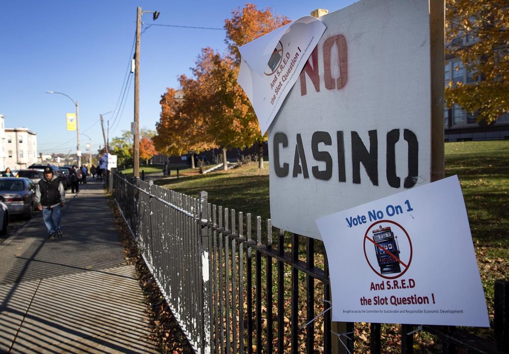 Signs against ballot Question 1, which would allow for a second slots parlor in Massachusetts, outside of East Boston High School. (Robin Lubbock/WBUR)