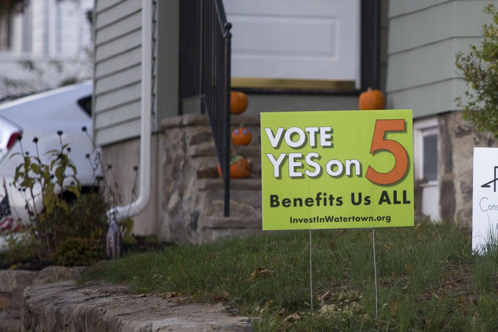 A sign in favor of adopting the Community Preservation Act is seen on Carroll Street in Watertown, one of the 11 communities to pass the measure. (Jesse Costa/WBUR)