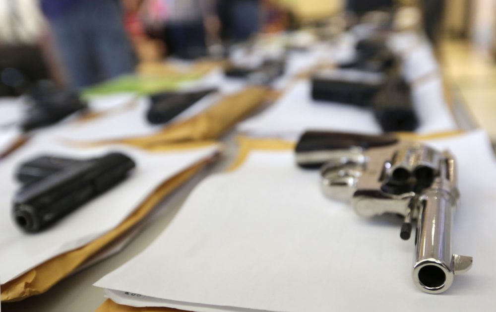In this Monday, July 7, 2014, file photo, Chicago police display some of the thousands of illegal firearms they confiscated so far that year in their battle against gun violence in Chicago. (M. Spencer Green/AP)