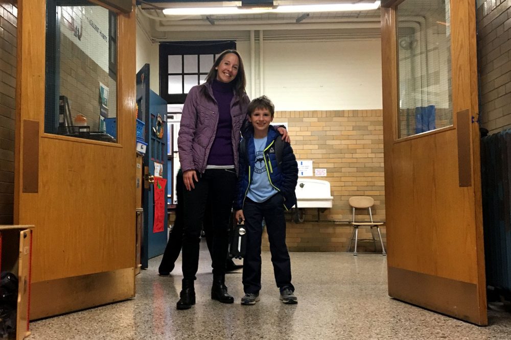 Toby Damon, 8, with his mother, Barb Damon, at the Phineas Bates Elementary School in Roslindale. (Tonya Mosley/WBUR)