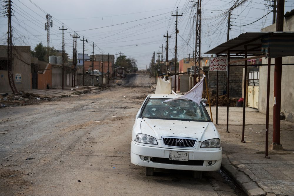A white flag is seen on a bullet ridden car in a deserted street in the Aden neighbourhood in Mosul, Iraq, on Nov. 16, 2016. Iraqi forces are fighting to take back control of the city from ISIS. (Odd Andersen/AFP/Getty Images)