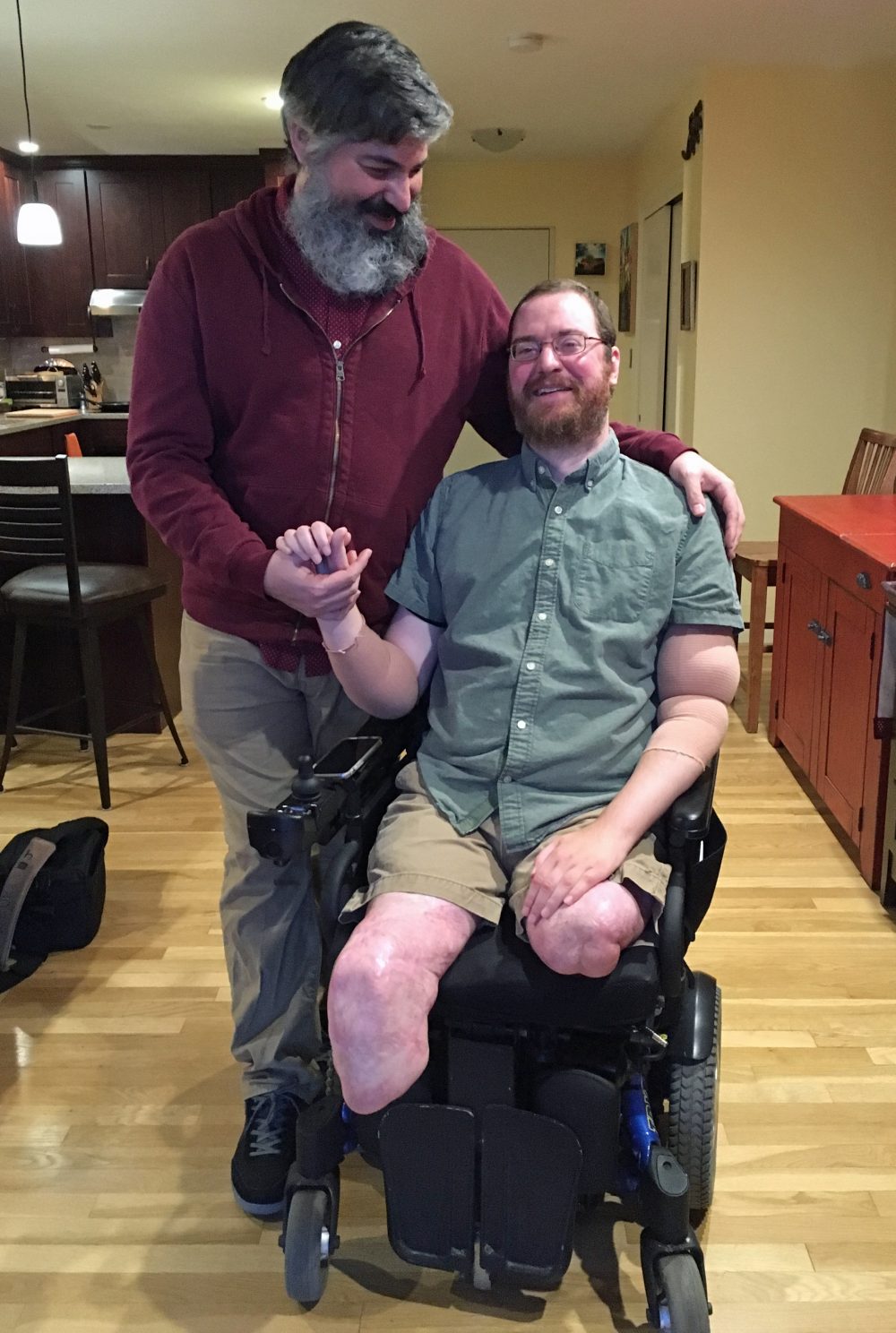 Will Lautzenheiser and his partner Angel Gonzalez at their home in Brookline, Mass. (Samantha Fields/Here &amp; Now)