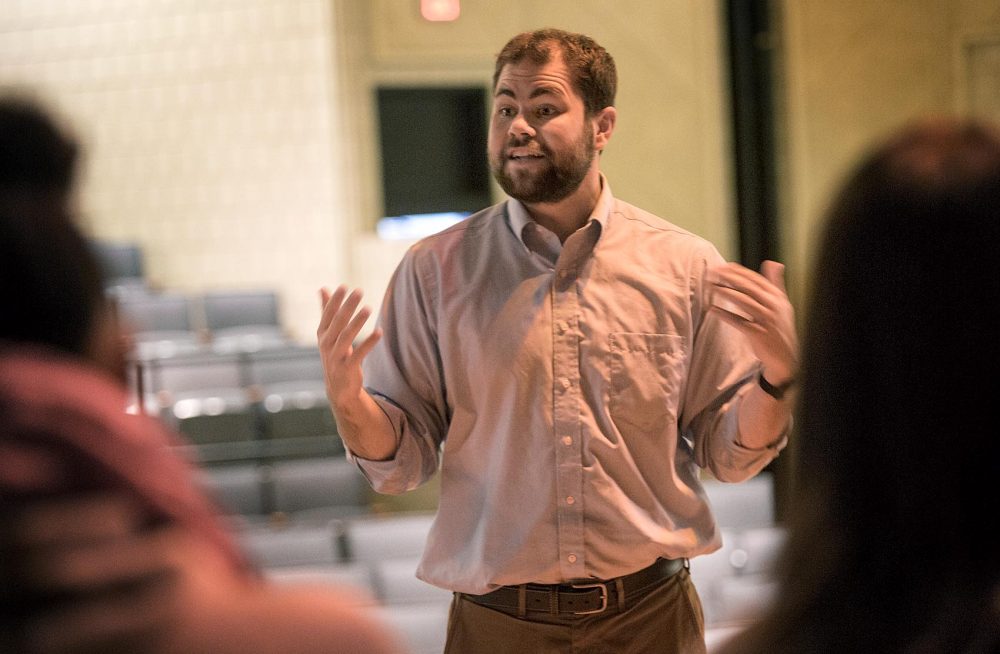 Theater teacher Alex Johnson talks with students at Charlestown High School. (Jesse Costa/WBUR)