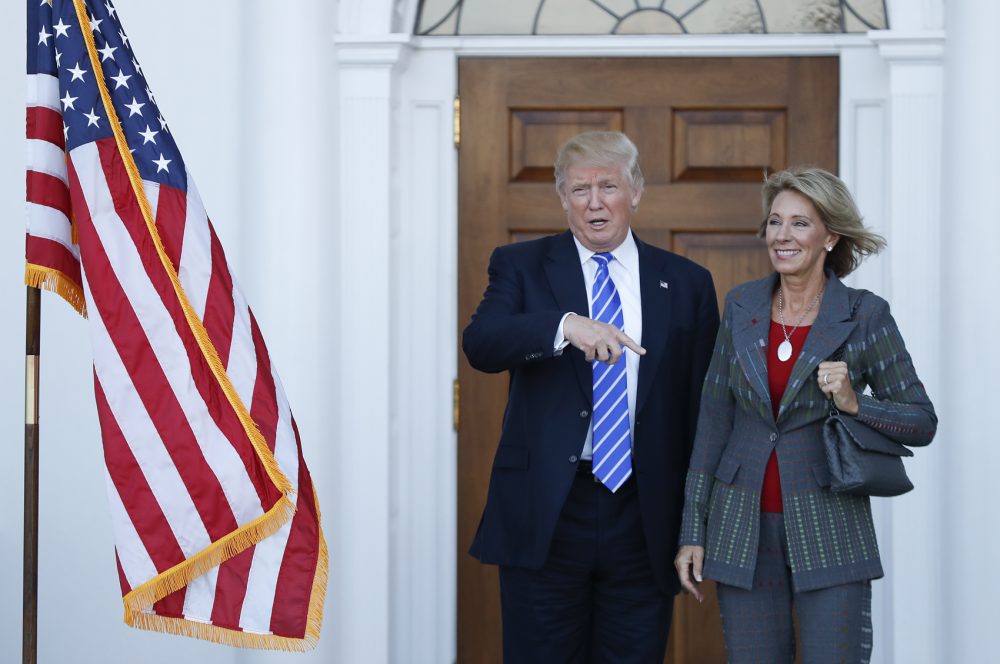 President-elect Donald Trump and Betsy DeVos, his pick for education secretary, pose for photos at Trump National Golf Club Bedminster clubhouse in Bedminster, N.J., Nov. 19, 2016. (Carolyn Kaster/AP)