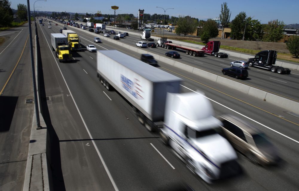 Truck and automobile traffic mix on Interstate 5, headed north through Fife, Wash., in August 2016. (Ted S. Warren/AP)