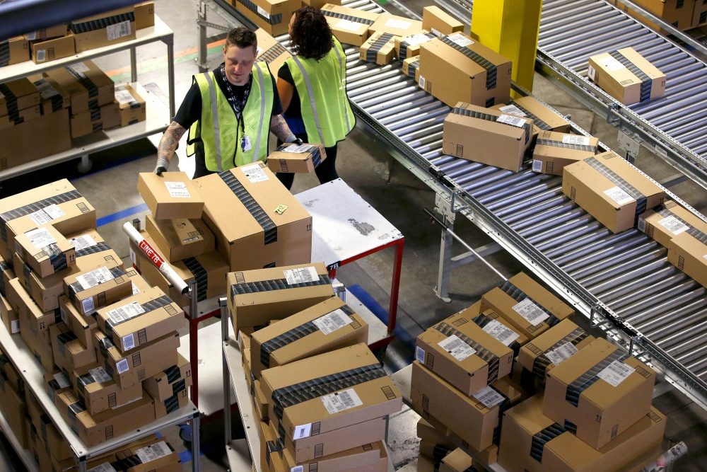 In this Monday, Dec. 2, 2013, file photo, Amazon.com employees organize outbound packages at an Amazon.com Fulfillment Center on Cyber Monday. (Ross D. Franklin/AP)