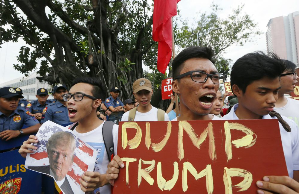 Filipino protesters shout slogans to denounce the election of U.S. President-elect Donald Trump in an anti-U.S. protest at the US Embassy in Manila, Philippines Thursday, Nov. 10, 2016 in Manila, Philippines. President-elect Donald Trump becomes the 45th U.S. President after defeating Democratic presidential candidate Hillary Clinton in the Nov.8, 2016 US election. (Bullit Marquez/AP)