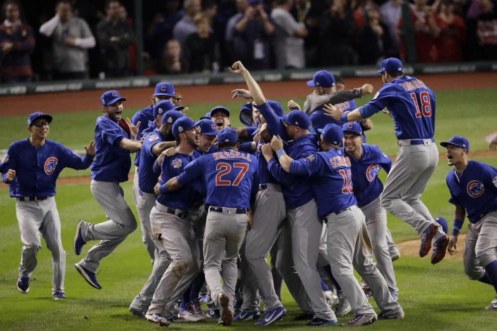 Chicago Cubs celebrate after beating the Cleveland Indians 8-7 in 10 innings to win the series 4-3. (Charlie Riedel/AP)