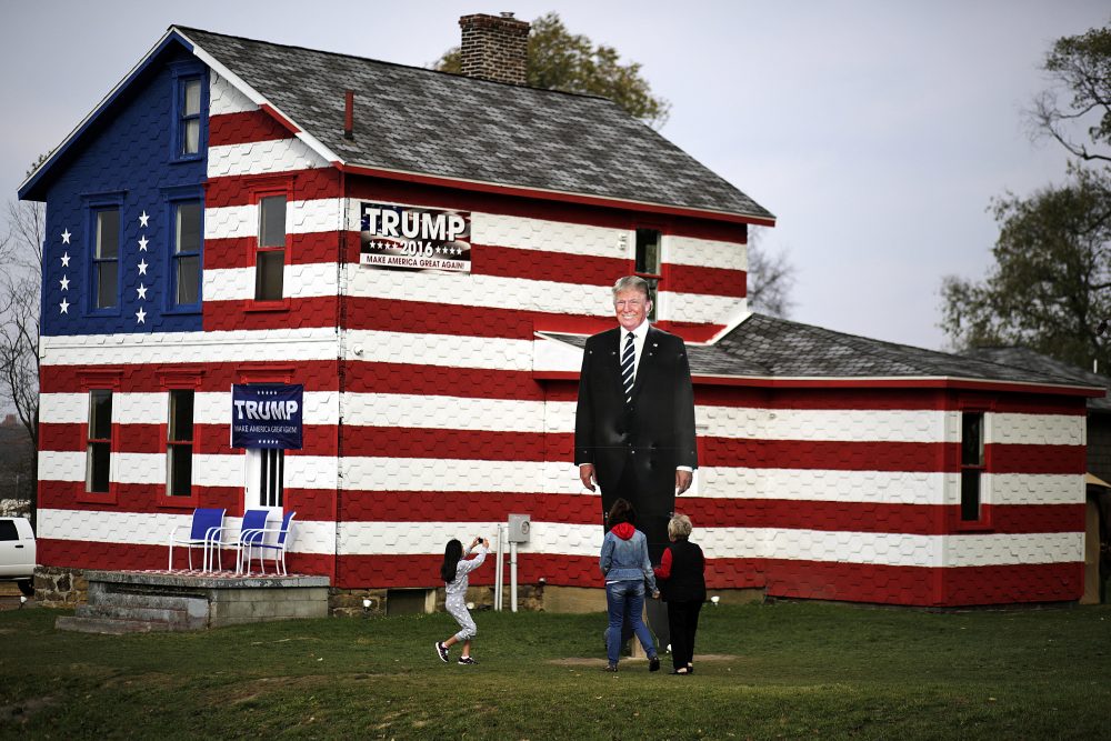 A young visitor takes a photo of a giant cutout of Republican candidate for president Donald Trump in front of the Trump House owned by Lisa Rossi in Youngstown, Pa, Tuesday, Nov. 8, 2016. (Gene J. Puskar/AP)