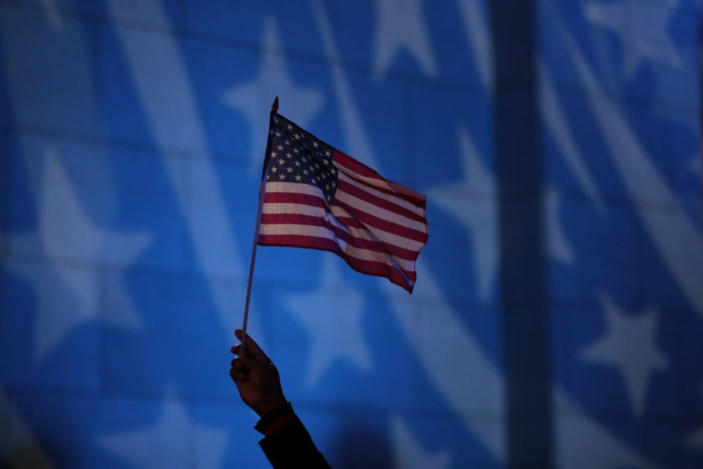 Howard Nizebeth waves a U.S. flag during an Election Day gathering at Rockefeller Center, Tuesday, Nov. 8, 2016, in New York. (Julio Cortez/AP)