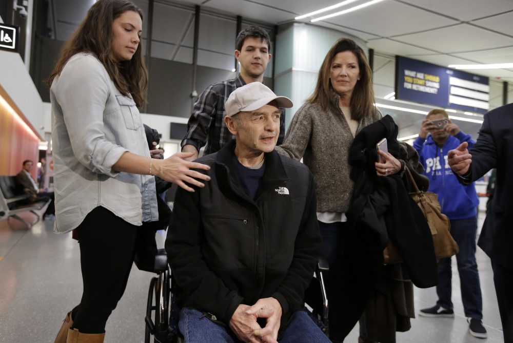 DiMasi speaks to the press alongside his stepchildren Ashley, left, and Christian, center top, and wife Debbie, right. (Steven Senne/AP)