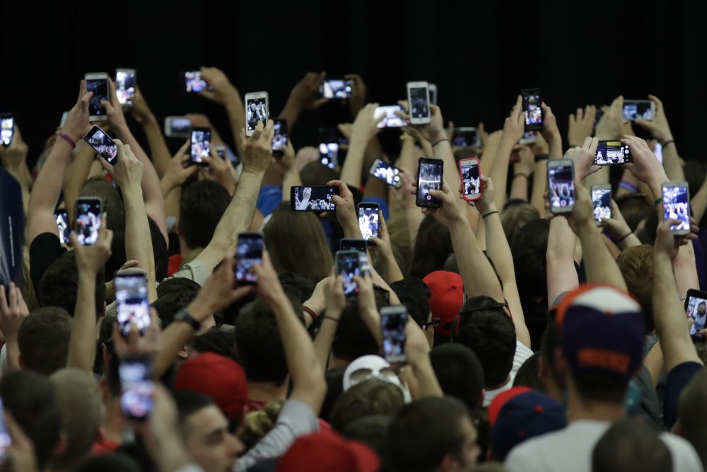 Audience members stretch for photos of Donald Trump before a campaign rally at West Chester University on April 25, 2016, in West Chester, Pa. (Matt Slocum/AP)