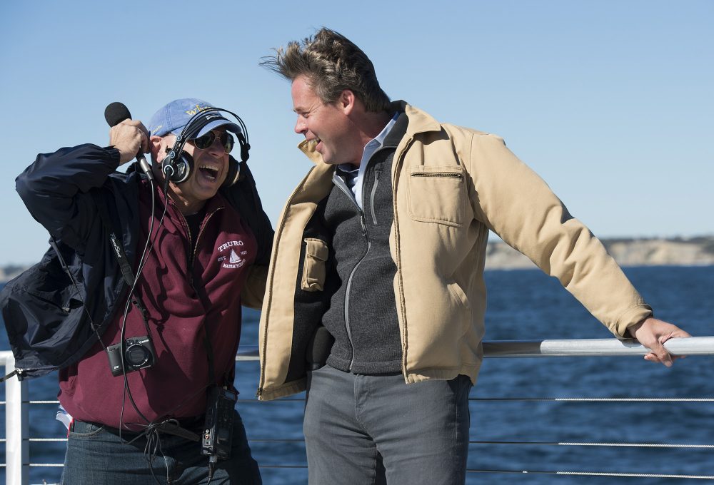 Our reporter Bruce tries to interview Matthew Morrissey, of Deepwater Wind, aboard the ferry with the wind blowing. (Courtesy Don Emmer/Agence France-Presse)