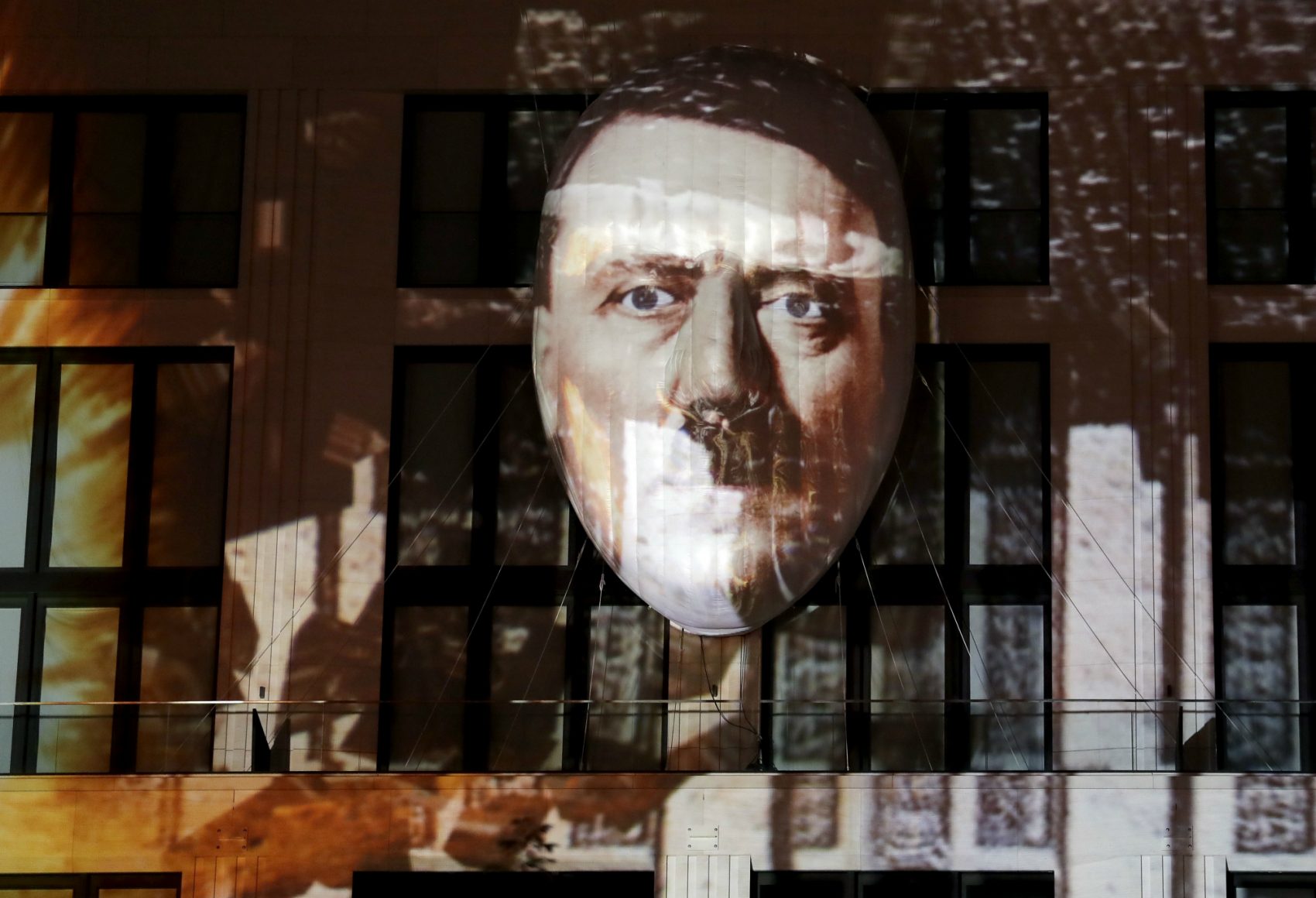 Julie Lindahl: "A democracy voted for an opportunist who became a dictator, and overnight he and his cronies dismantled an entire society and provoked a war that devoured the lives of 60 million people." Pictured: The face of Adolf Hitler projected onto a 3D canvas as part of an art installation during a rehearsal for the 'Berlin Leuchtet' (Berlin shines) festival in Berlin, Germany, Thursday, Sept. 29, 2016. (Michael Sohn/AP)