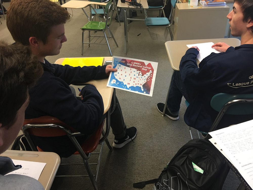 Lowell High School students examine a map showing electoral college votes. (Tonya Mosley/WBUR)