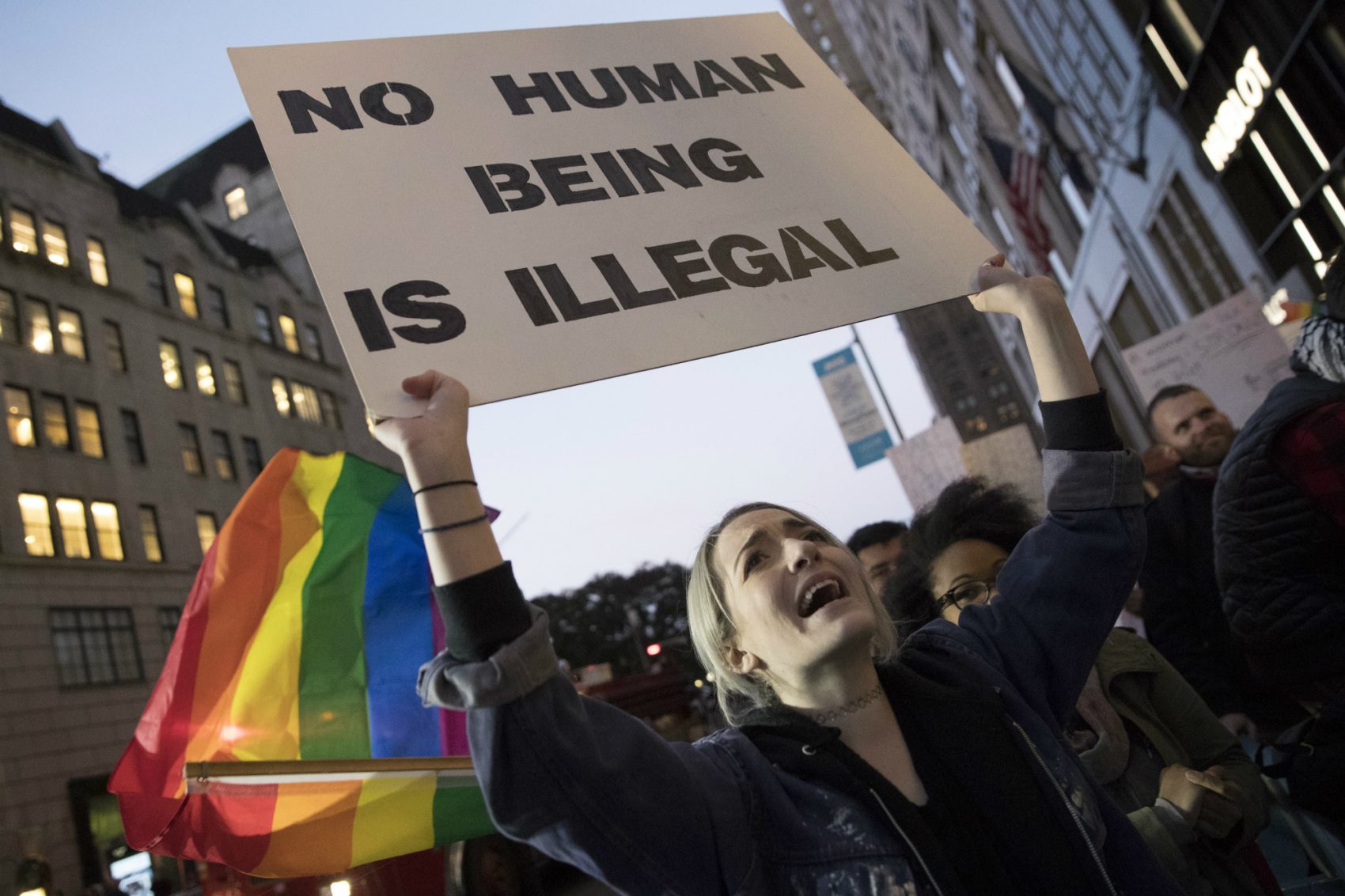 Acacia Handel holds a sign during a demonstration outside Trump Tower in New York on Saturday, Nov. 12, 2016, to protest against President-elect Donald Trump. (Mary Altaffer/AP)
