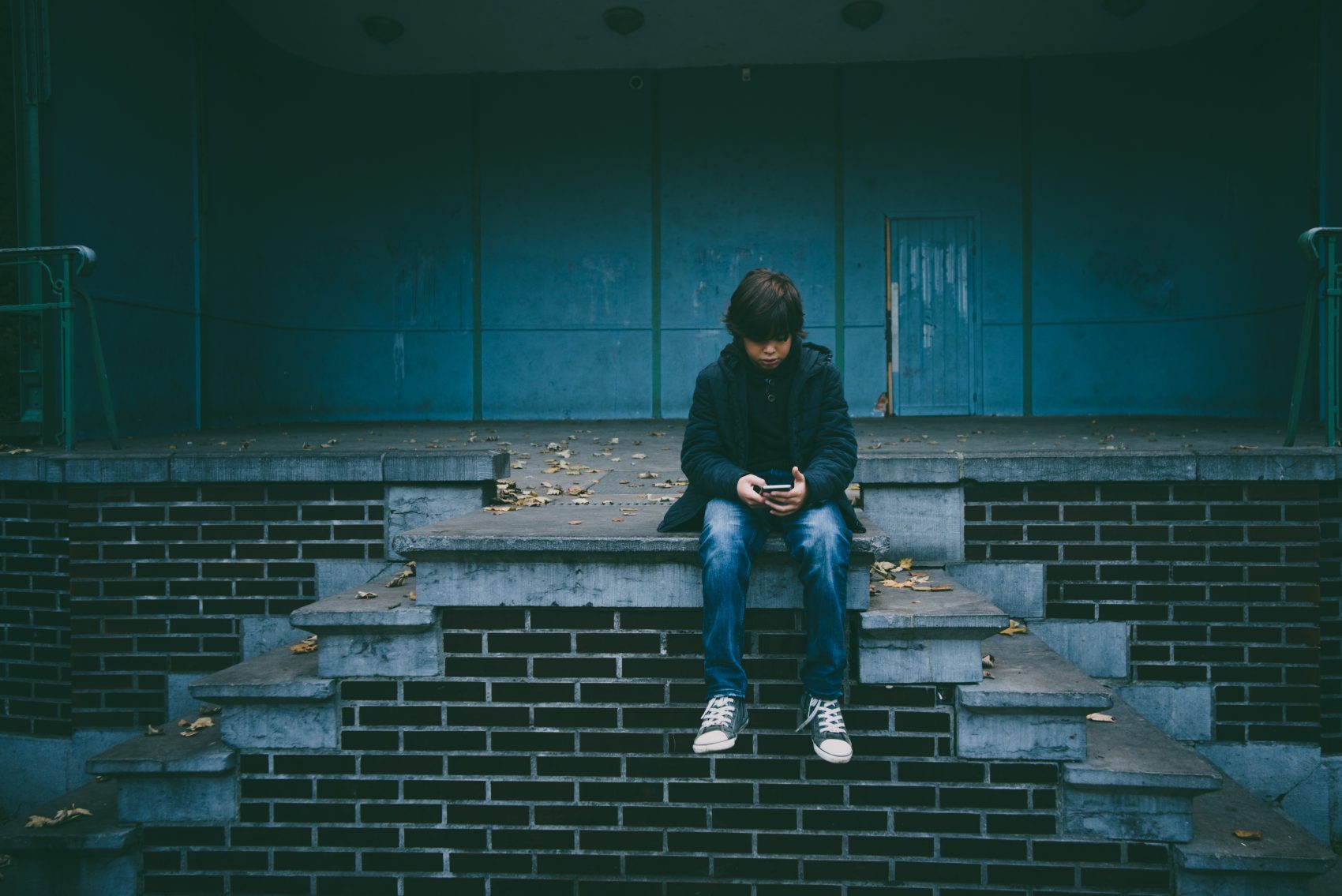 A child checking his cell phone. (Gaelle Marcel/Unsplash)