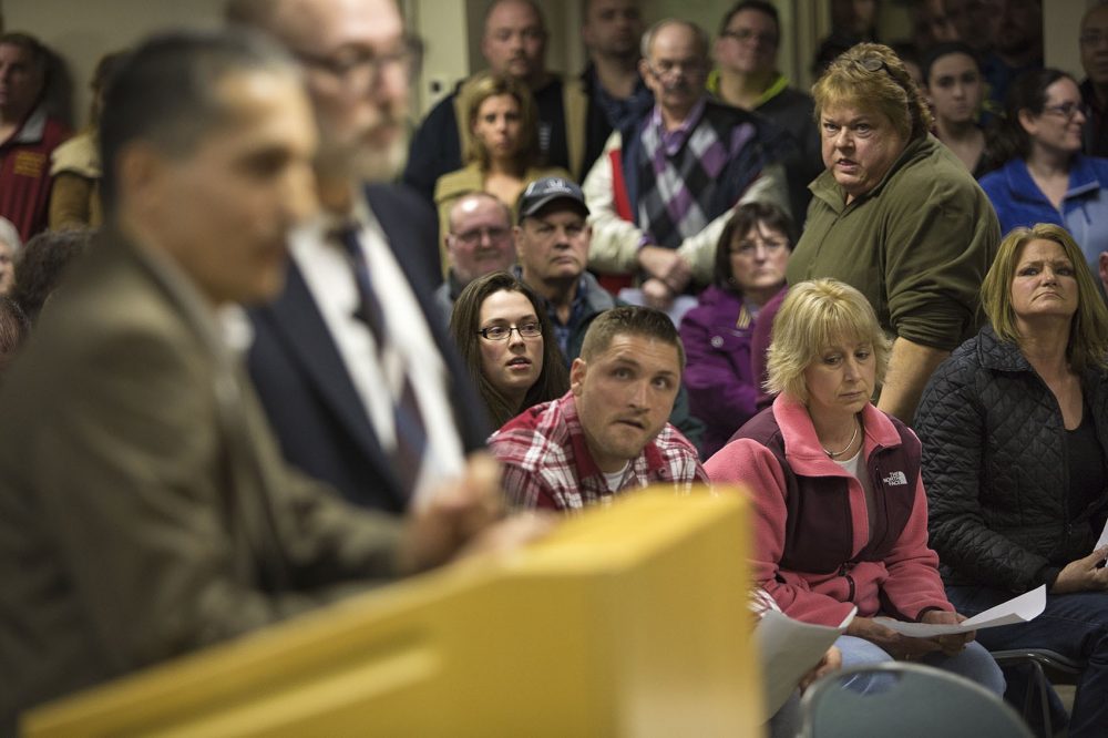 Dudley residents look on as attorney Jason Talerman, right, and civil engineer Imad Zrein present the Muslim cemetery plan for Corbin Road at a packed public hearing on Thursday evening. (Jesse Costa/WBUR)