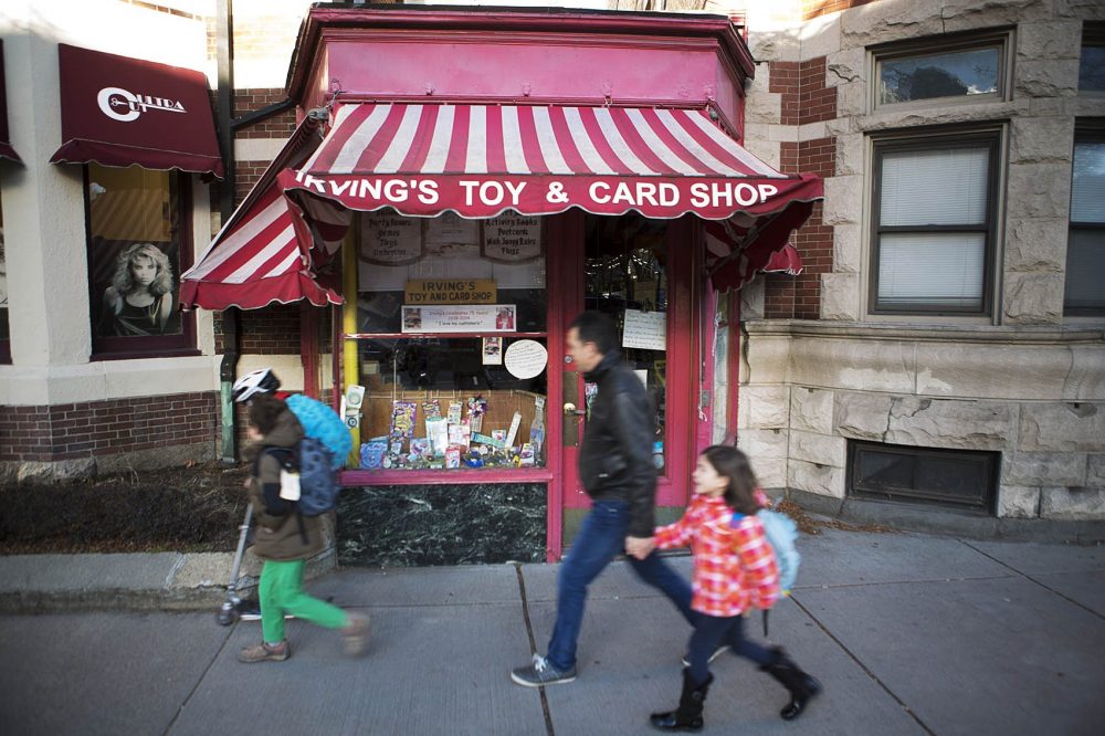 People pass by Irving's Toy and Card Shop in Brookline. (Jesse Costa/WBUR)