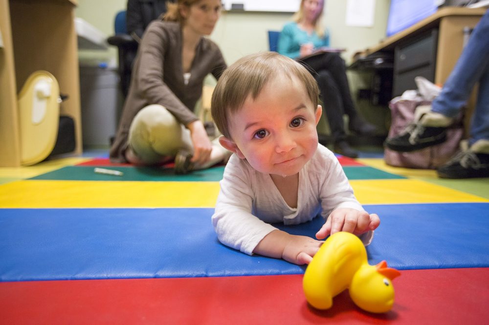 James crawls after a rubber duck during a recent checkup at the Newborn Developmental Follow-Up Clinic at MGH. (Jesse Costa/WBUR)