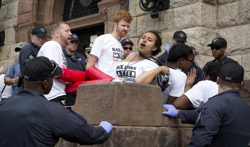 Black Lives Matter protesters linked together outside Cambridge City Hall. (Robin Lubbock/WBUR)