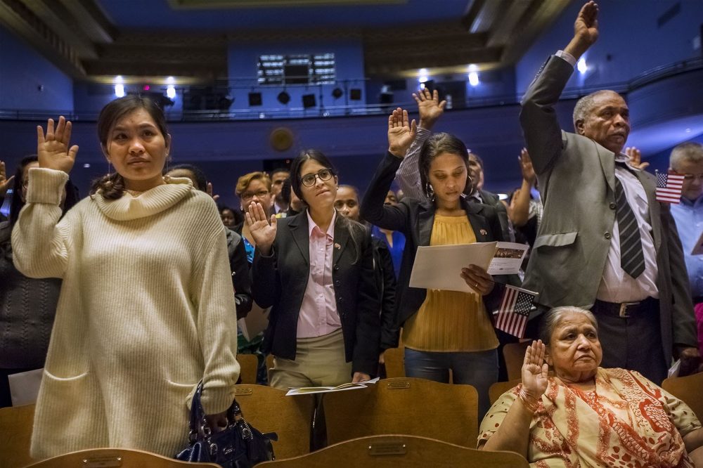 Close to 150 naturalization applicants took the Oath of Allegiance during a ceremony at Jenkins Auditorium at Malden High School on Oct. 18. (Jesse Costa/WBUR)