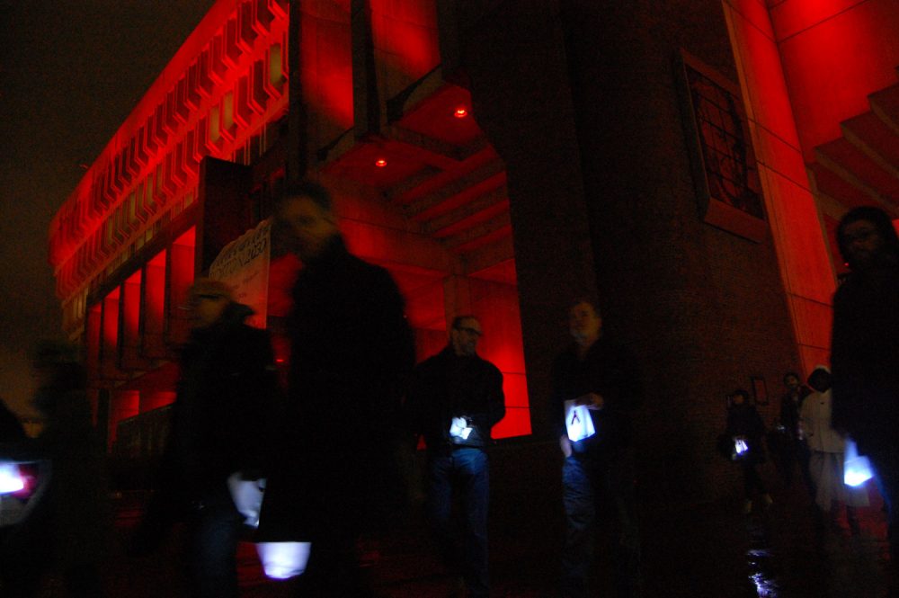 The 25th annual Medicine Wheel procession began at Boston City Hall, which was lit red for the occasion. (Greg Cook/WBUR)
