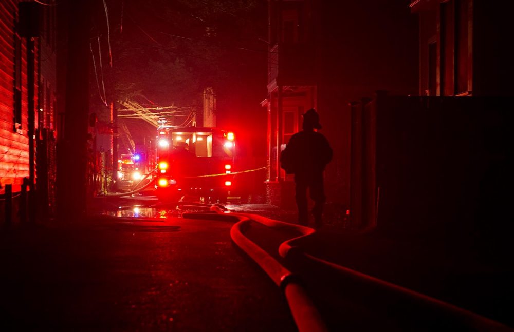 Fire trucks on York Place in Cambridge, Mass. as fire fighters battle a ten alarm fire. (Robin Lubbock/WBUR)