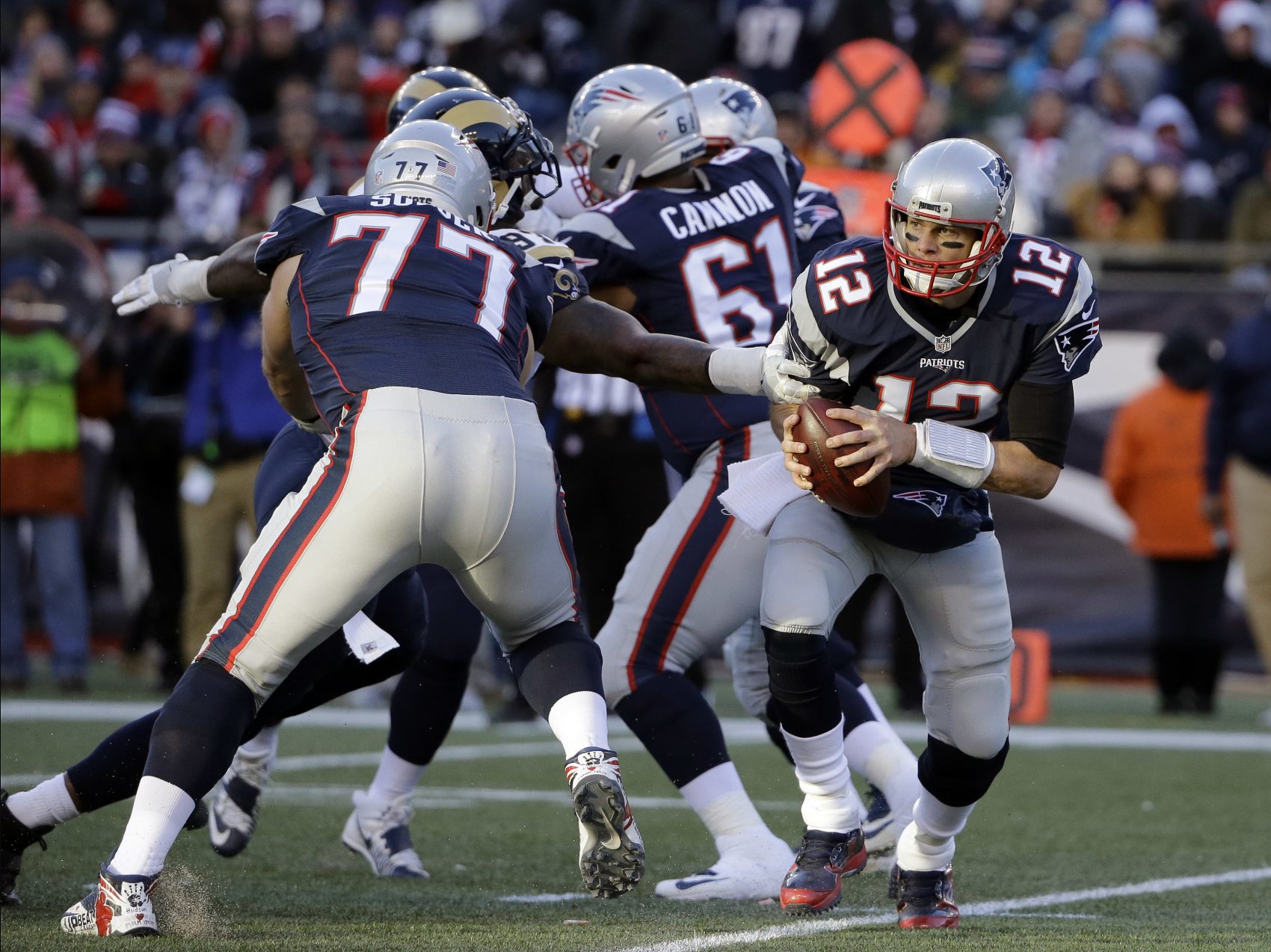 New England Patriots quarterback Tom Brady (12) scrambles during the second half of an NFL football game against the Los Angeles Rams on Sunday in Foxborough, Mass. (Elise Amendola/AP)