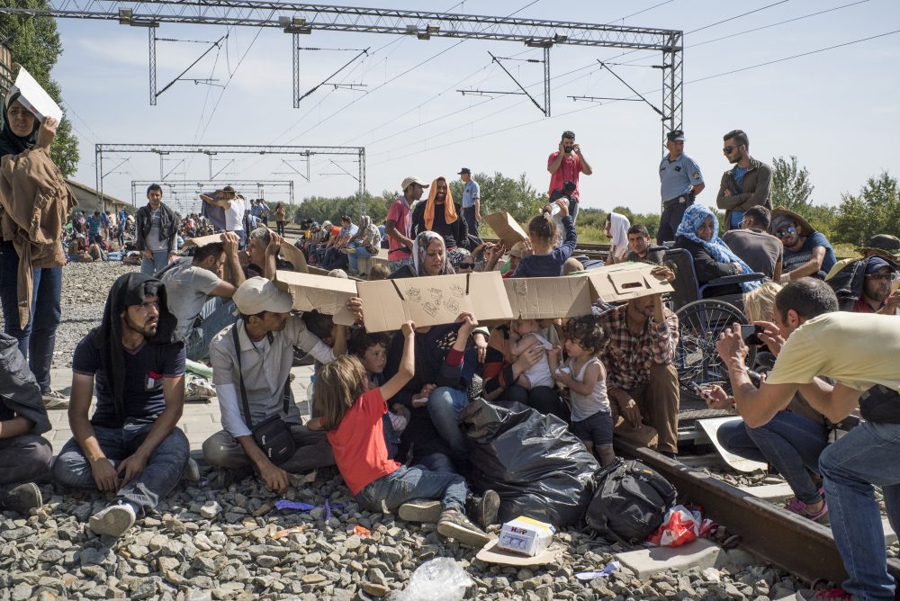 The train station on the Croatian-Serbian border, Sept. 17, 2015.  It was over 100 degrees Fahrenheit and thousands of migrants waited for trains to take them to Zagreb, while Croatian riot police kept them fenced in. (Courtesy Peter van Agtmael/Magnum Photos)