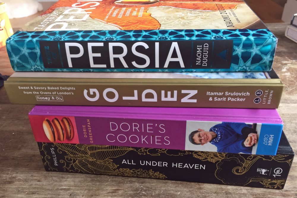 Four of our resident chef Kathy Gunst's favorite cookbooks of 2016 (top to bottom): “Taste of Persia,&quot; by Naomi Duguid, &quot;Golden,&quot; by Itamar Srulovich and Sarit Packer, &quot;Dorie's Cookies,&quot; by Dorie Greenspan and &quot;All Under Heaven,&quot; by Carolyn Phillips. (Kathy Gunst for Here & Now)