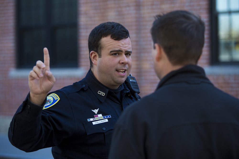 Cambridge police officer Jason Callinan, a drug recognition expert, or DRE, performs the Horizontal Gaze Nystagmus (HGN) on Jeremy Warnick, the department's spokesman, as part of a demonstration. (Jesse Costa/WBUR)