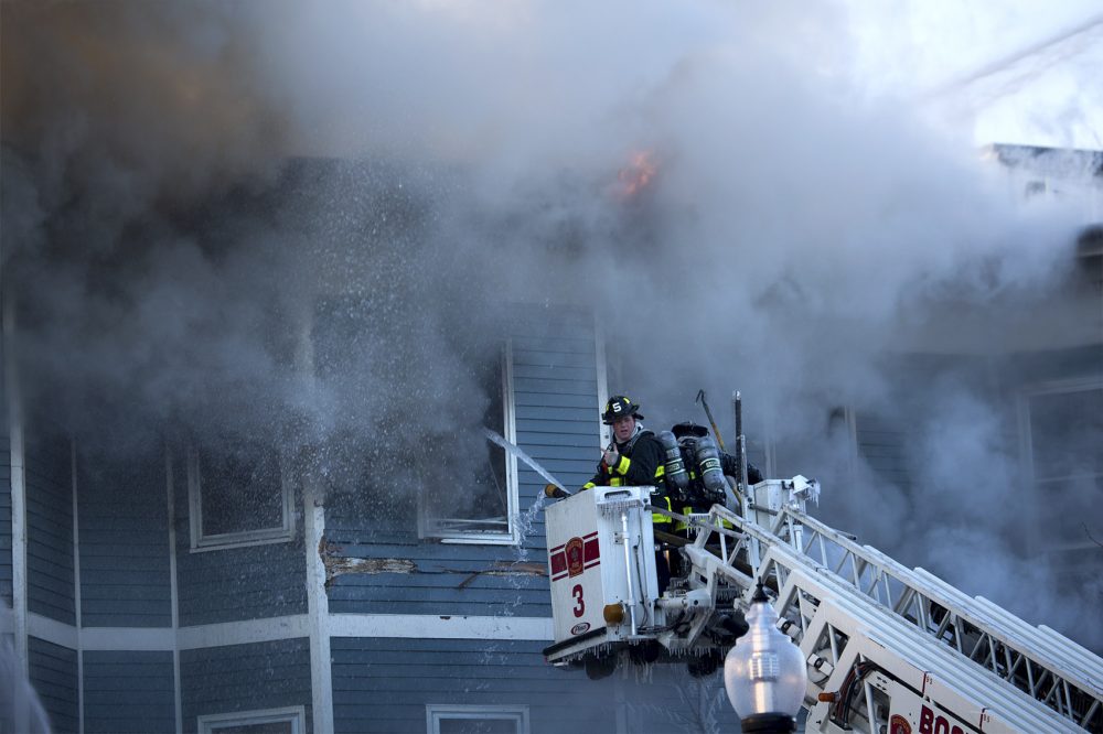 Boston Firefighters battle a fire on Bunker Hill Street in Charlestown. (Jesse Costa/WBUR)