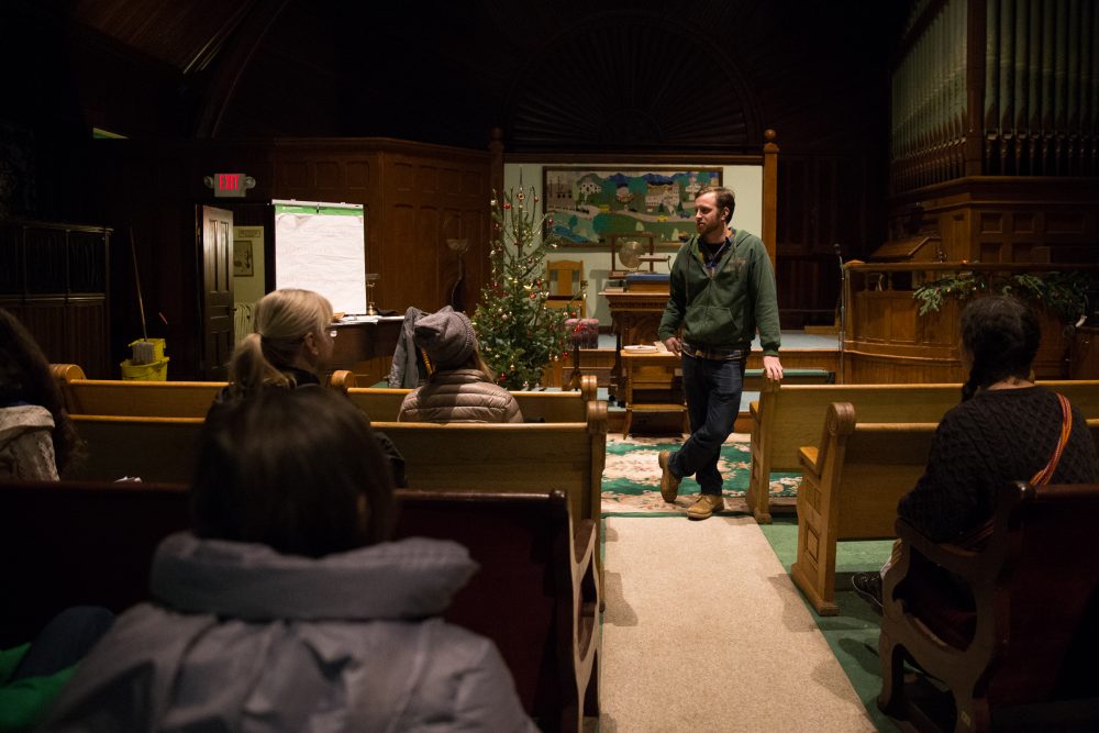 Morgan Denehy stands at the front of Rutland’s Unitarian Universalist church. He's been leading free classes in Arabic to community members. (Ryan Caron King/NENC)