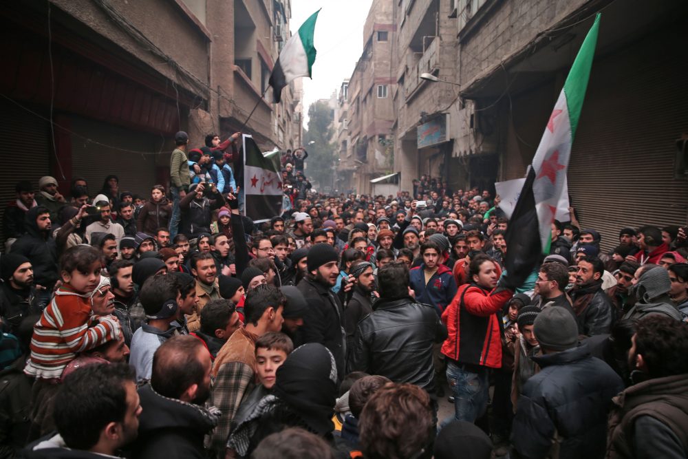 Syrian demonstrators gather in the rebel-held town of Saqba, on the eastern outskirts of the capital Damascus, during a demonstration in solidarity with the inhabitants of the embattled Syrian city of Aleppo on Dec. 16, 2016. (Msallam Abdalbaset/AFP/Getty Images)