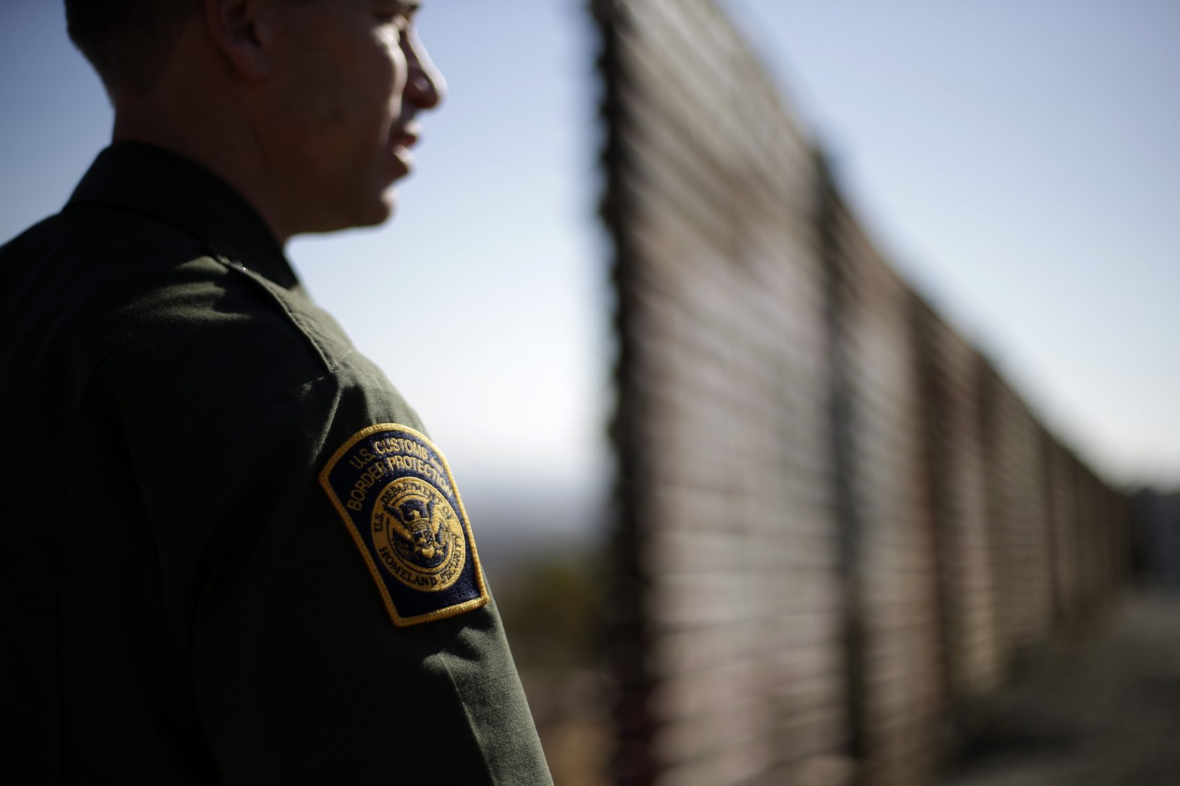 In this June 13, 2013 picture, U.S. Border Patrol agent Jerry Conlin looks to the north near where the border wall ends as is separates Tijuana, Mexico, left, and San Diego, right. (Gregory Bull/AP)