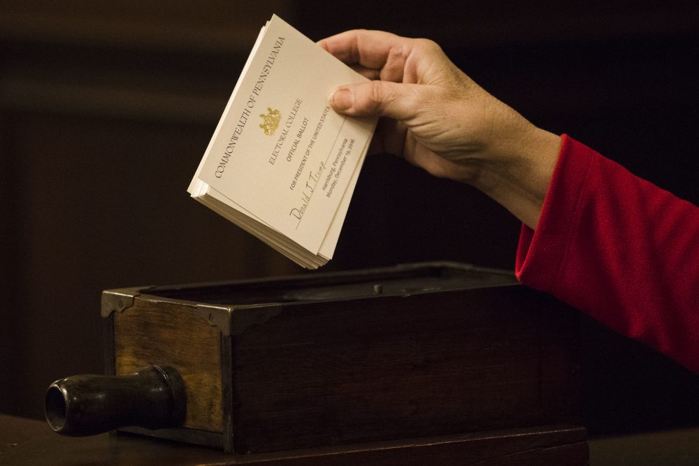 A teller places ballots into a box after tallying elector's votes during Pennsylvania's 58th Electoral College at the state Capitol in Harrisburg, Pa., Monday, Dec. 19, 2016. (Matt Rourke/AP)
