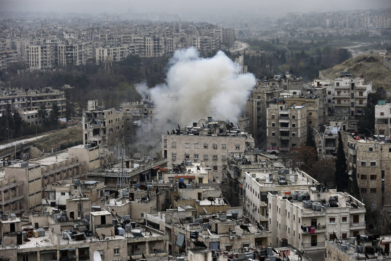 Smoke rises after rebel fighters launch a mortar shell on residential neighborhood in west Aleppo, Syria, Monday, Dec. 5, 2016. The government seized large swaths of the Aleppo enclave under rebel control since 2012 in the offensive that began last week. (Hassan Ammar/AP)