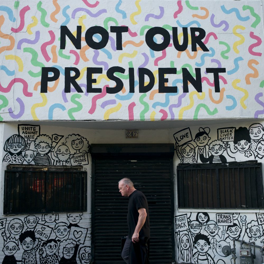Reports of the death of identity politics have been greatly exaggerated, writes Susan E. Reed. Pictured: A man walks past a building with the phrase &quot;Not Our President&quot; written on the facade to protest against President-elect Donald Trump Thursday, Dec. 8, 2016, in Los Angeles. (Jae C. Hong/AP)
